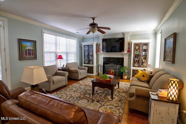 living room featuring crown molding, wood-type flooring, and ceiling fan