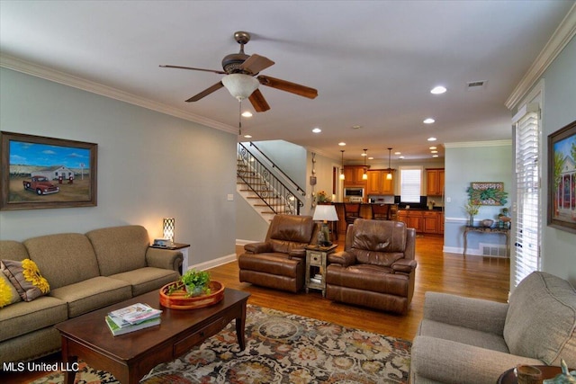 living room featuring light hardwood / wood-style flooring and ornamental molding