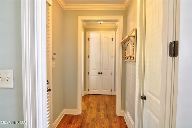 corridor featuring ornamental molding and dark hardwood / wood-style floors