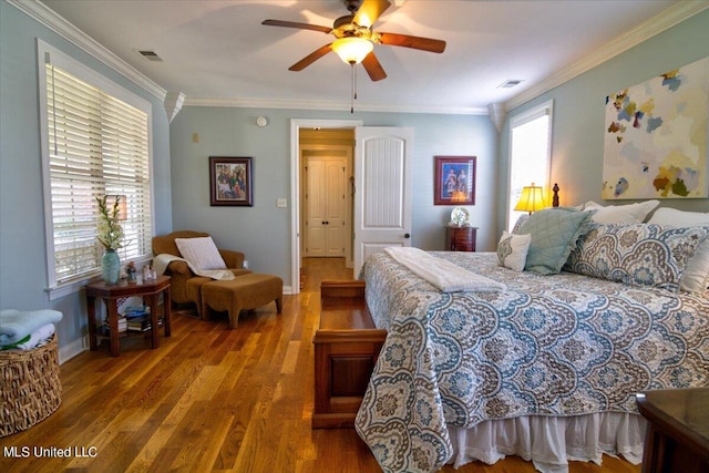 bedroom with ceiling fan, ornamental molding, multiple windows, and hardwood / wood-style floors