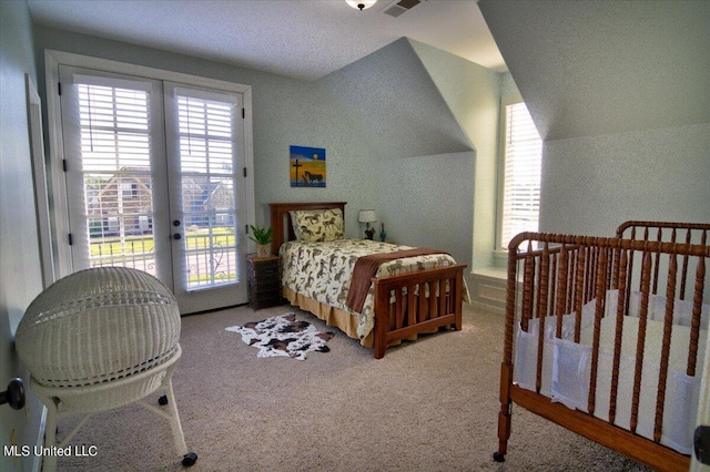 carpeted bedroom with lofted ceiling, french doors, access to exterior, and a textured ceiling