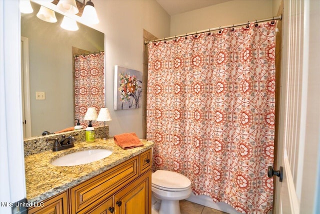 bathroom featuring vanity, toilet, curtained shower, and tile patterned flooring