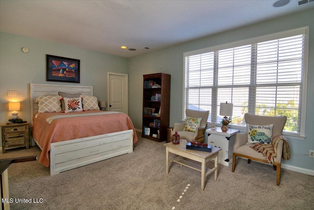 carpeted bedroom featuring multiple windows