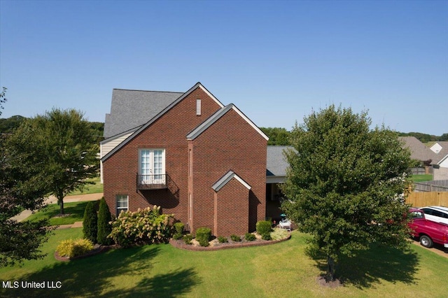 view of side of home with a lawn