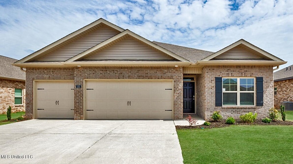 428 Piney Dr, Pearl, MS 39208 - view of front of house with a garage, driveway, a front lawn, and brick siding