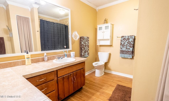 bathroom featuring vanity, toilet, crown molding, and hardwood / wood-style floors