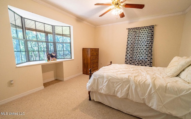 carpeted bedroom with ornamental molding and ceiling fan