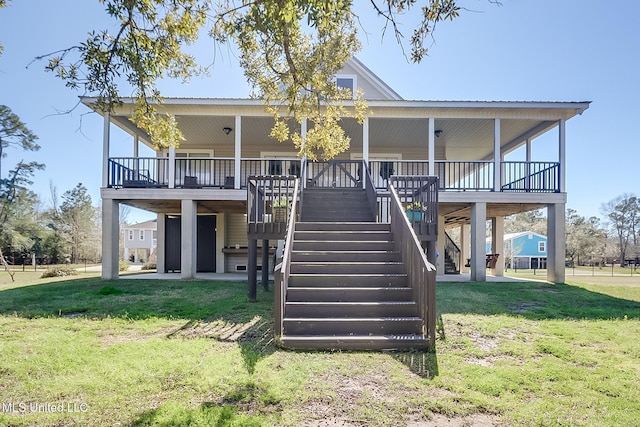 back of property featuring stairs and a yard