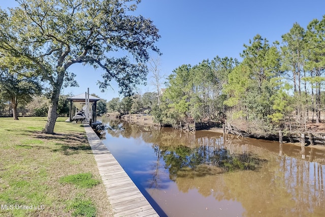 dock area with a lawn and a water view