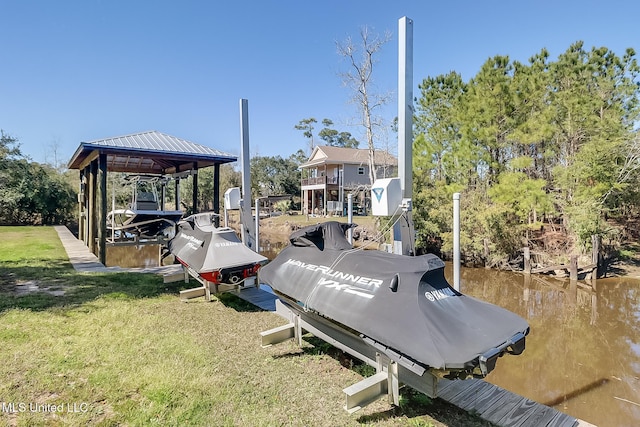 view of dock featuring a lawn and boat lift