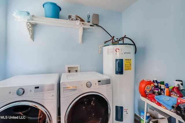 washroom featuring washer and dryer, laundry area, and electric water heater