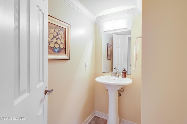 bathroom featuring baseboards and ornamental molding