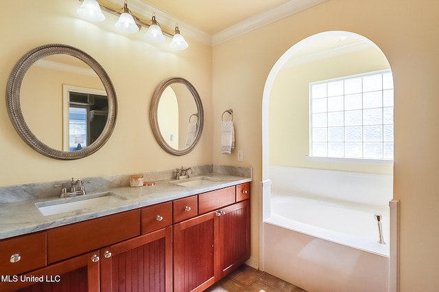 full bath featuring a garden tub, double vanity, a sink, and crown molding