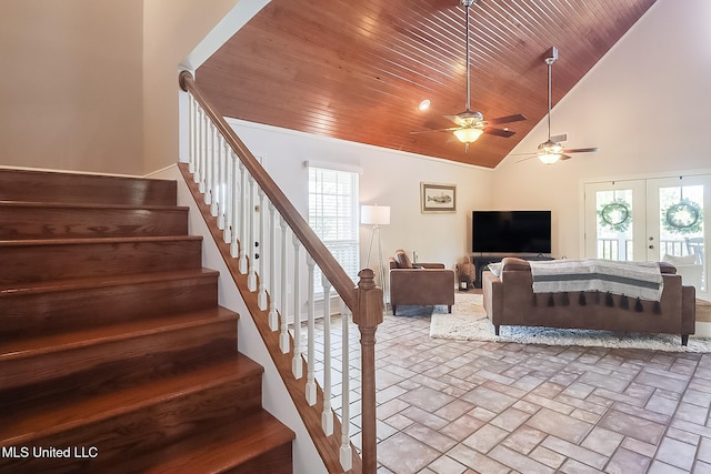 living area featuring high vaulted ceiling, wood ceiling, stairway, and french doors