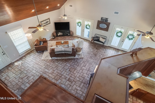 living area featuring high vaulted ceiling, french doors, visible vents, and wooden ceiling