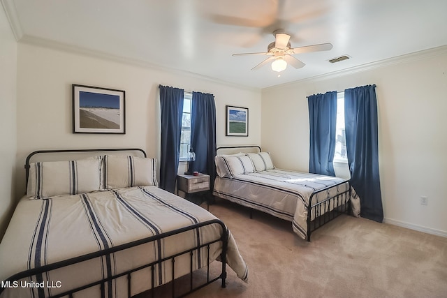 carpeted bedroom featuring ornamental molding, multiple windows, and visible vents