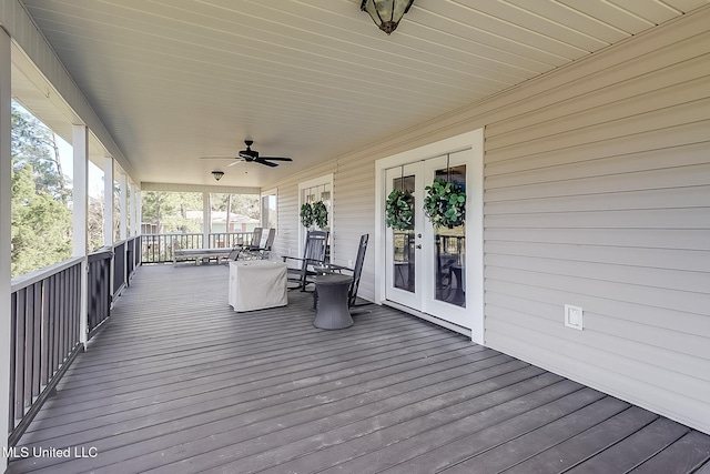 wooden deck with ceiling fan and french doors