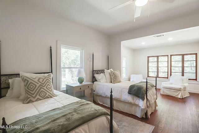 bedroom with visible vents, ceiling fan, and wood finished floors