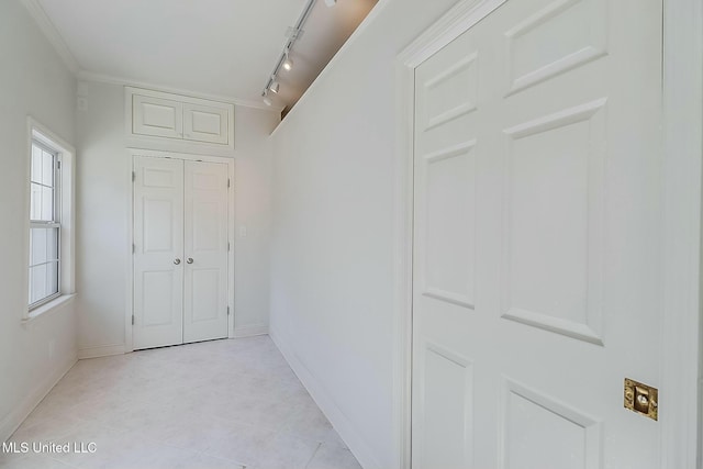 hall with baseboards and light tile patterned floors