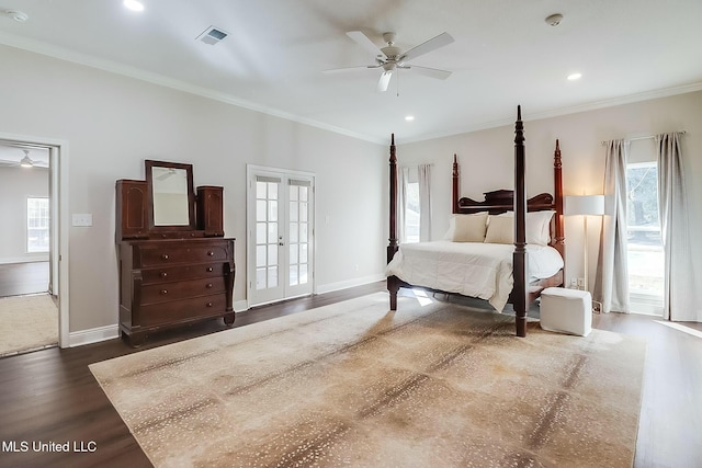 bedroom featuring baseboards, ornamental molding, dark wood finished floors, and french doors