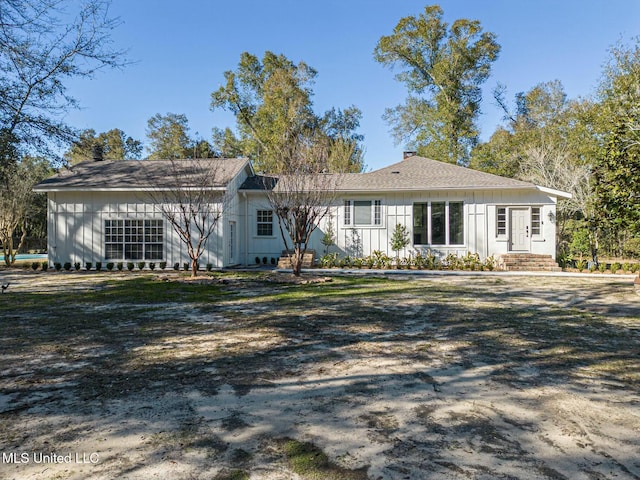 ranch-style house with board and batten siding