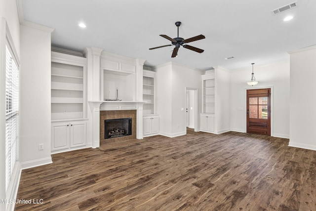 unfurnished living room with dark hardwood / wood-style floors, ceiling fan, and crown molding