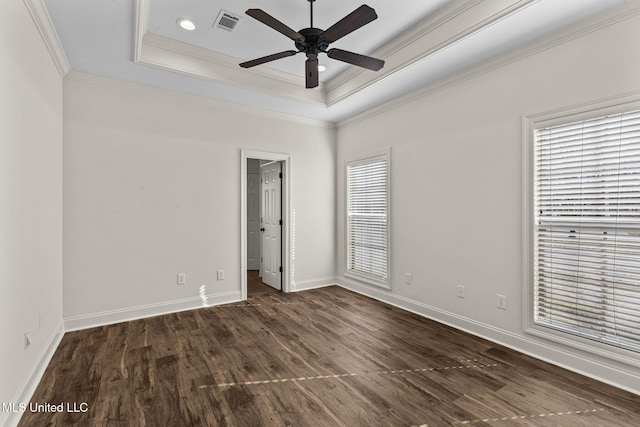 unfurnished bedroom featuring ceiling fan, dark hardwood / wood-style flooring, a raised ceiling, and crown molding