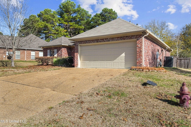 ranch-style home with a front yard and a garage