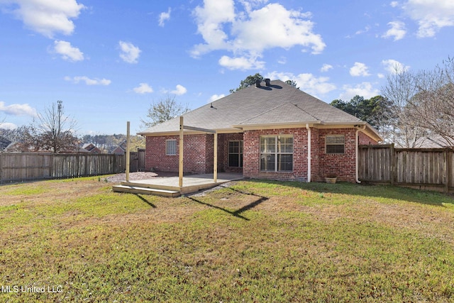 rear view of house with a yard and a wooden deck