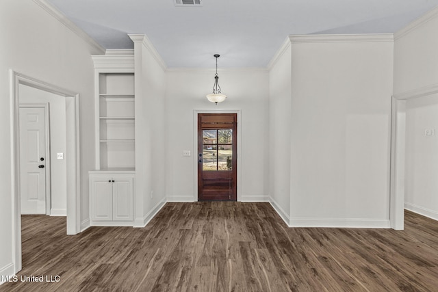 entrance foyer with ornamental molding and dark wood-type flooring