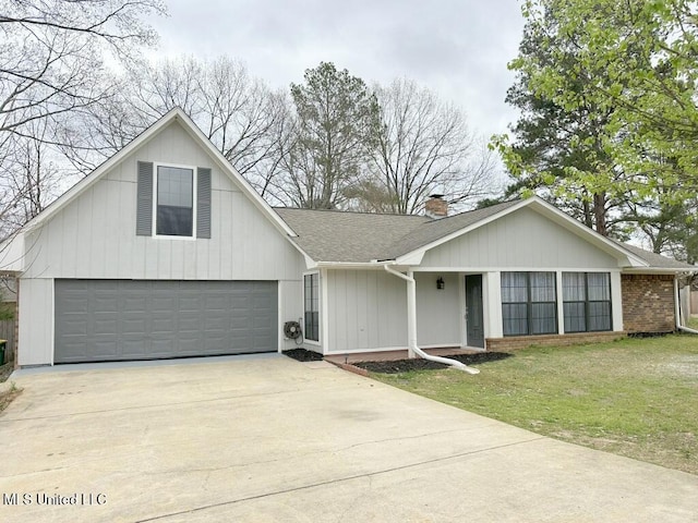 view of front of property featuring driveway, roof with shingles, a front yard, brick siding, and a chimney