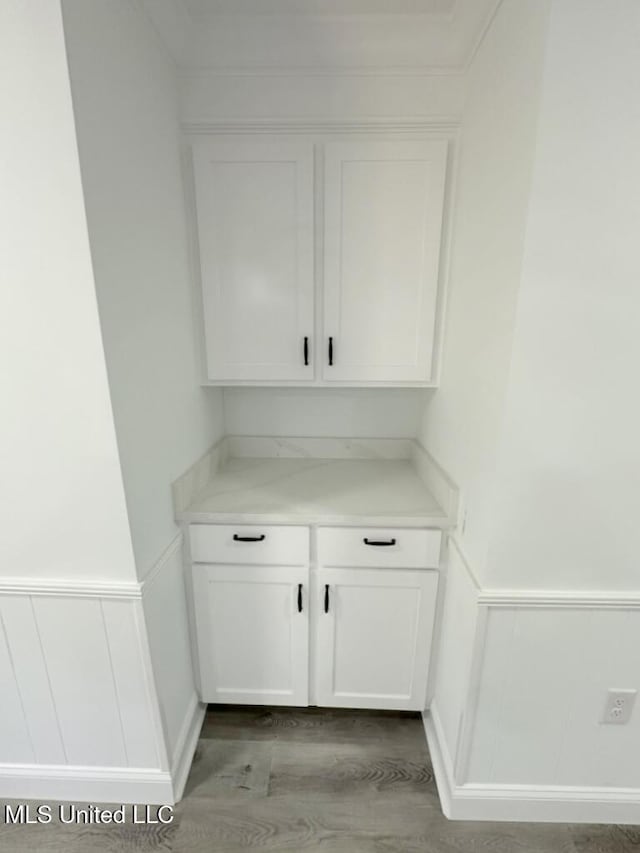 room details featuring wood finished floors and wainscoting