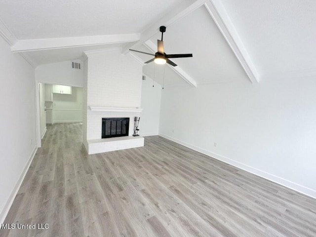 unfurnished living room featuring a ceiling fan, visible vents, vaulted ceiling with beams, light wood-style floors, and a brick fireplace