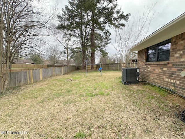 view of yard featuring central AC and a fenced backyard