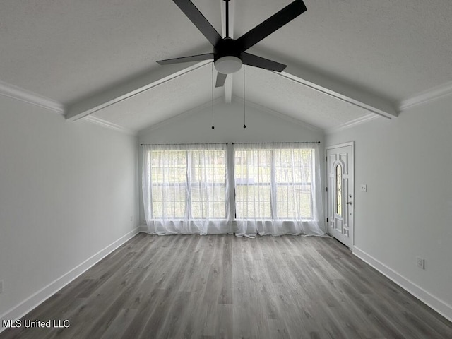 unfurnished living room featuring a ceiling fan, wood finished floors, baseboards, lofted ceiling with beams, and ornamental molding