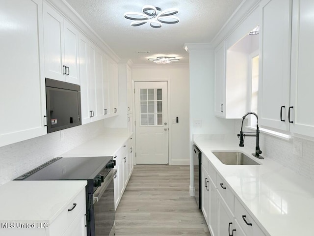 kitchen with a sink, electric range oven, white cabinetry, crown molding, and dishwasher