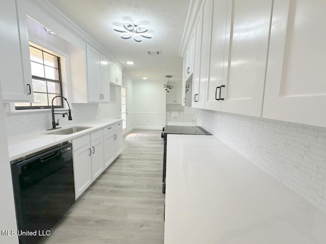 kitchen featuring visible vents, light wood-type flooring, a sink, black dishwasher, and white cabinetry