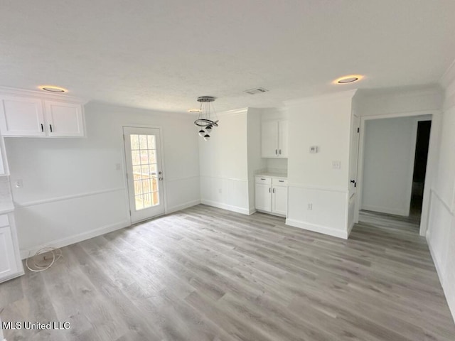 interior space featuring visible vents, baseboards, and light wood-type flooring