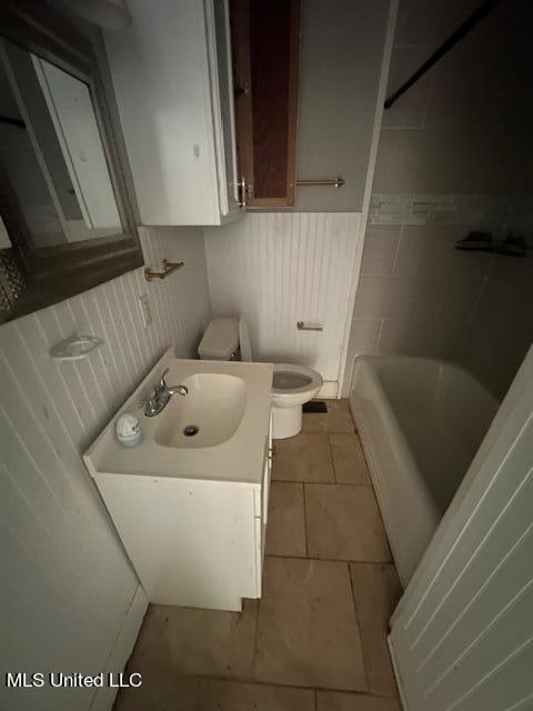 bathroom with vanity, toilet, and tile patterned floors