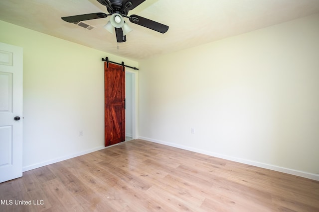 18 Crossgates Dr, Brandon, MS 39042 - spare room with light wood-style flooring, ceiling fan, a barn door, and baseboards