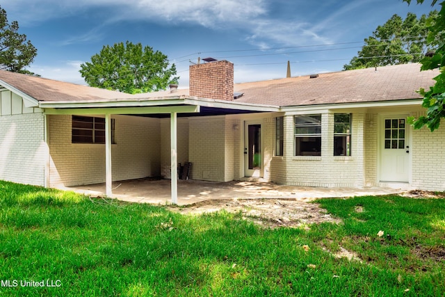 18 Crossgates Dr, Brandon, MS 39042 - rear view of house with brick siding, a chimney, a yard, and a shingled roof