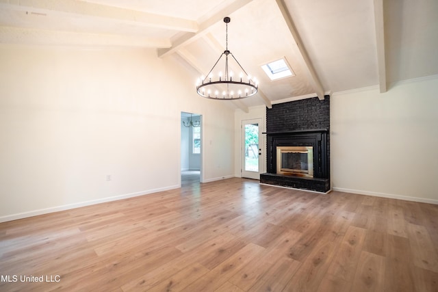 18 Crossgates Dr, Brandon, MS 39042 - unfurnished living room with a chandelier, beamed ceiling, light wood-style floors, a brick fireplace, and high vaulted ceiling