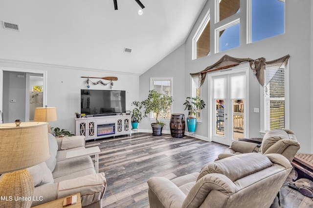 living room with high vaulted ceiling, wood-type flooring, and french doors