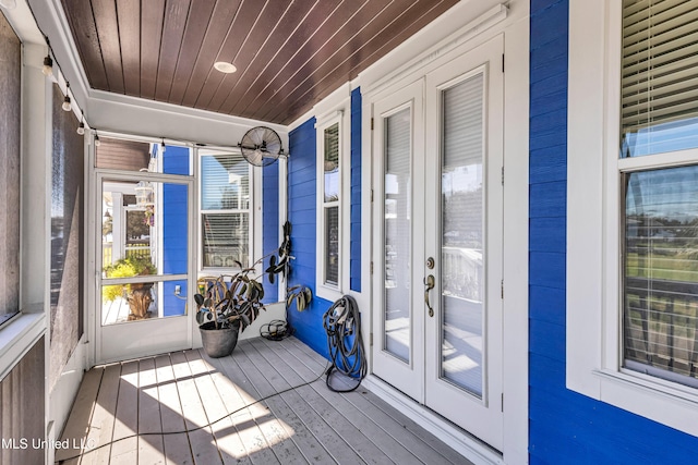 unfurnished sunroom featuring wood ceiling