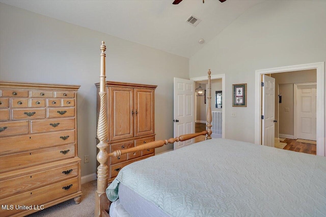 bedroom featuring ceiling fan, light wood-type flooring, and high vaulted ceiling