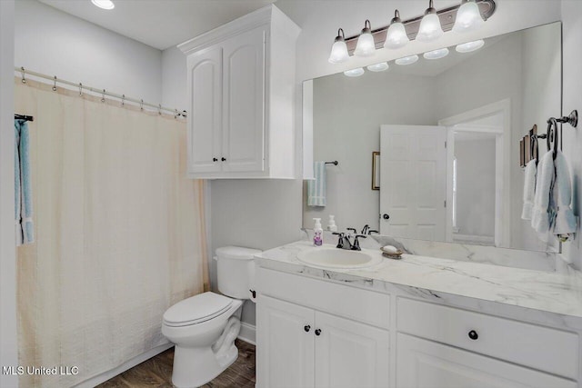 bathroom featuring hardwood / wood-style floors, vanity, and toilet