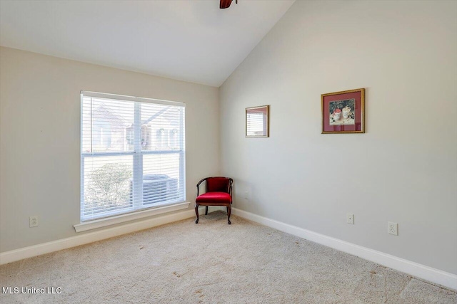 sitting room featuring ceiling fan, light colored carpet, and lofted ceiling