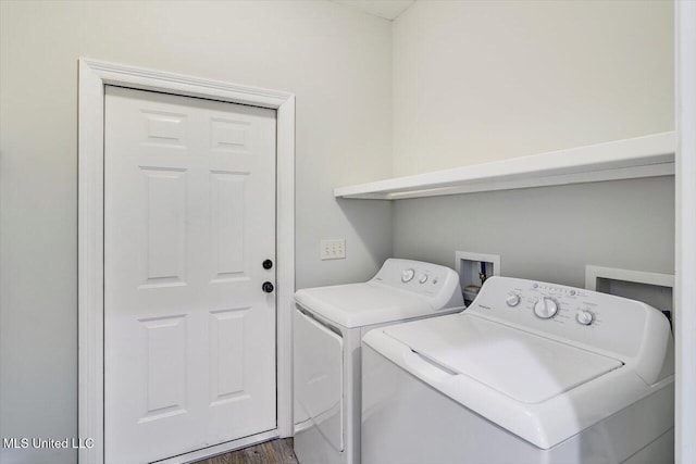 clothes washing area with dark wood-type flooring and washing machine and clothes dryer