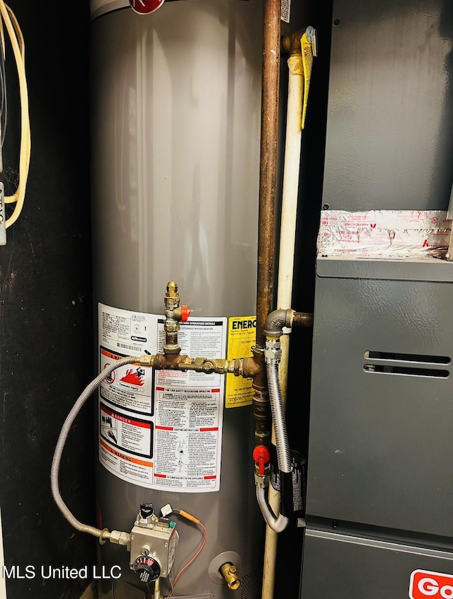 utility room featuring heating unit and water heater