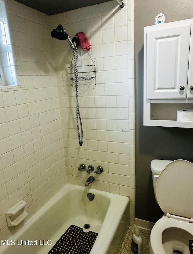 bathroom featuring bathing tub / shower combination and toilet